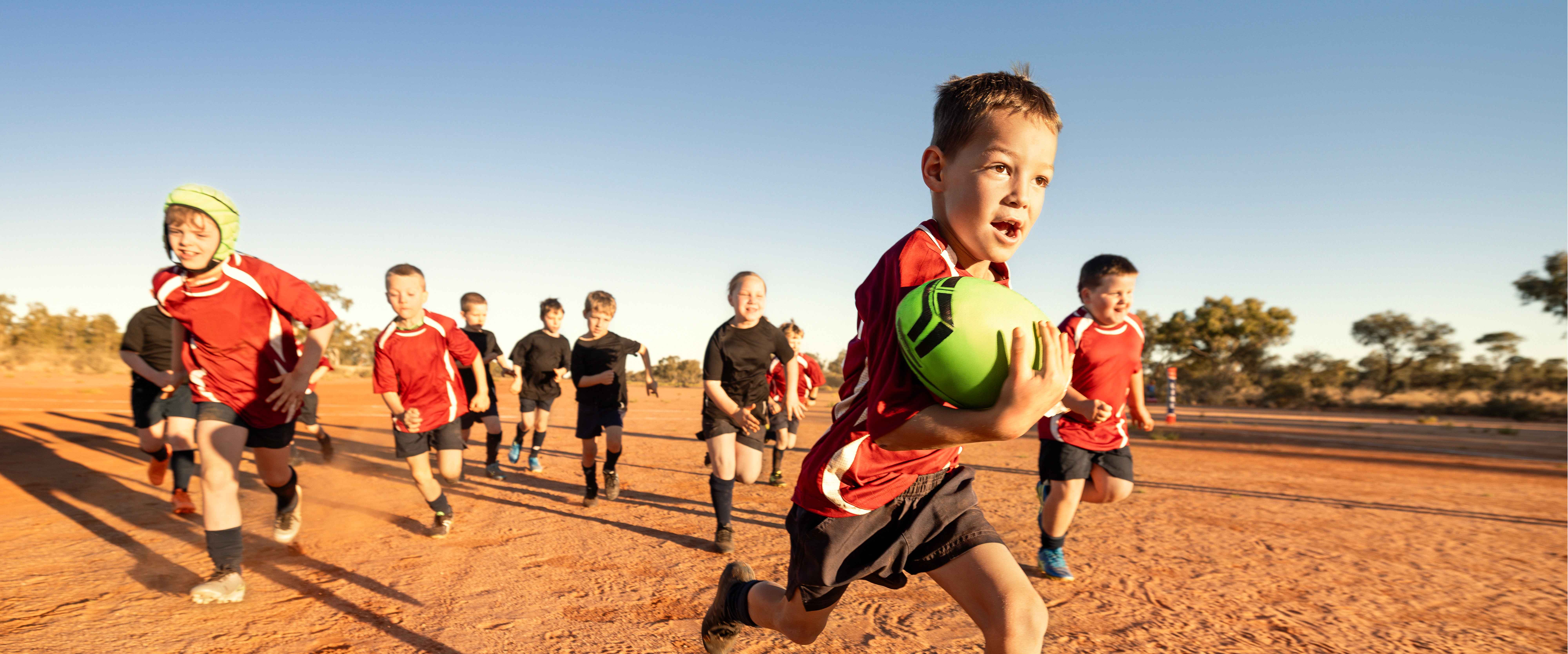 Children playing rugby in outback Queensland